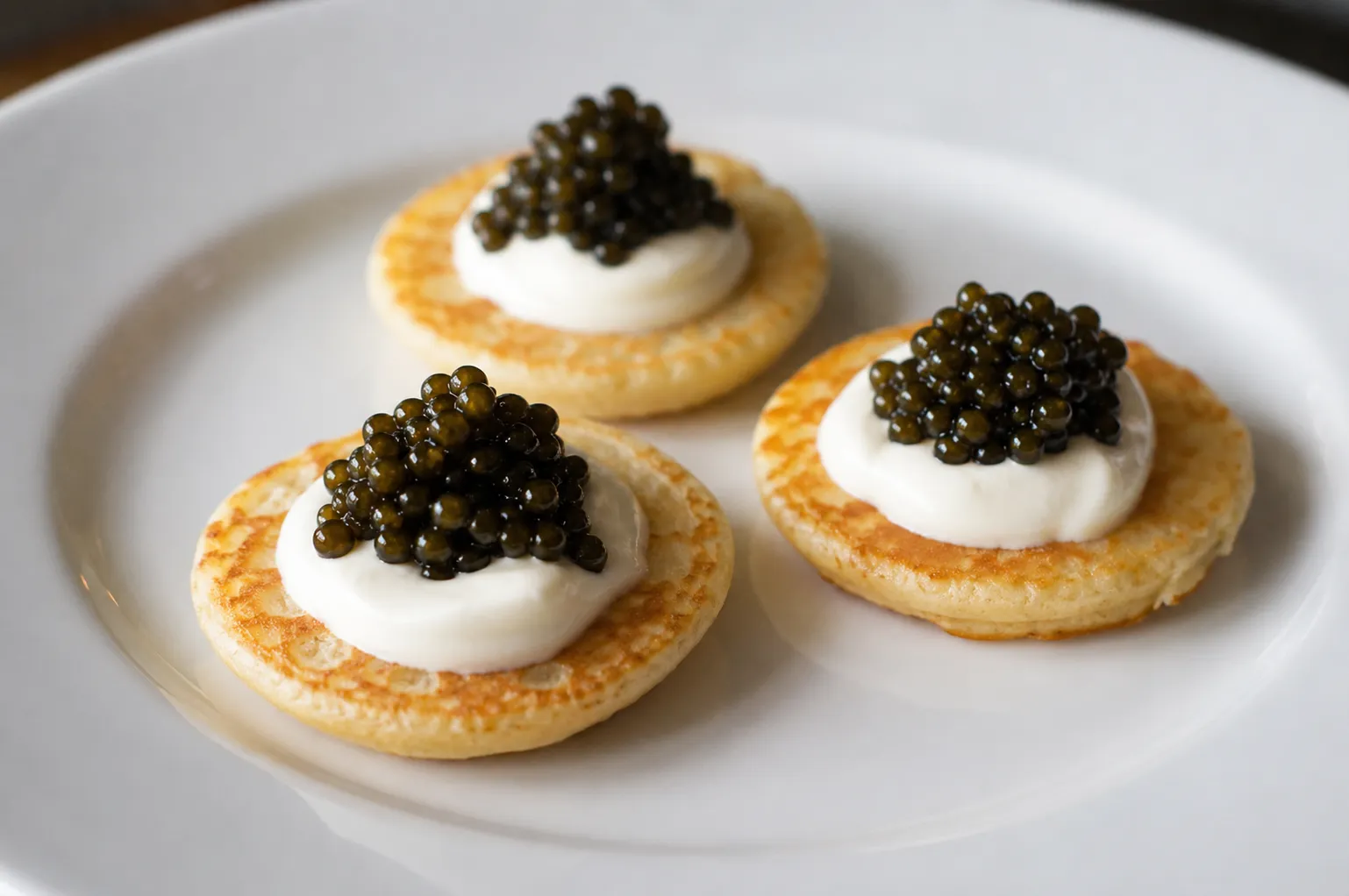 Blini with crème fraîche and moustellar caviar